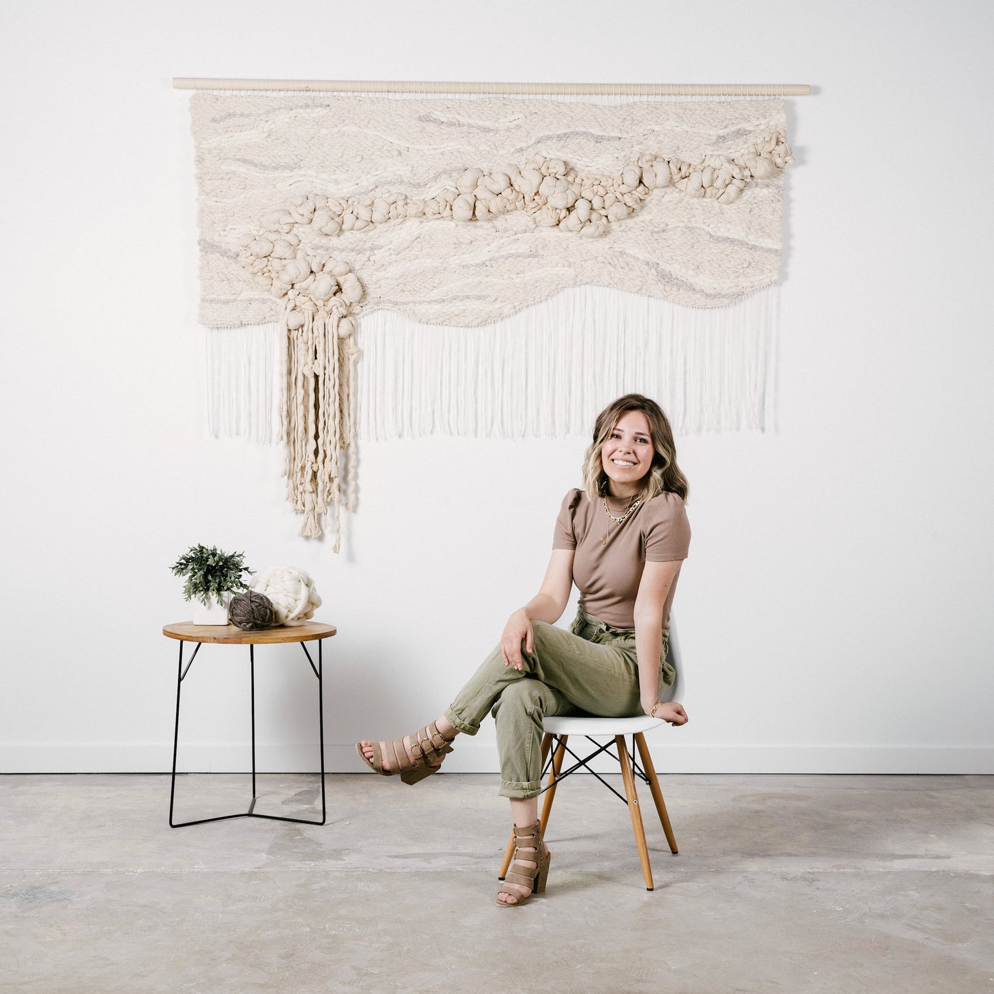 Eco-conscious woven tapestry utilizing plant-based fibers, highlighting the beauty of sustainable materials. Accent color in tones of beige.
