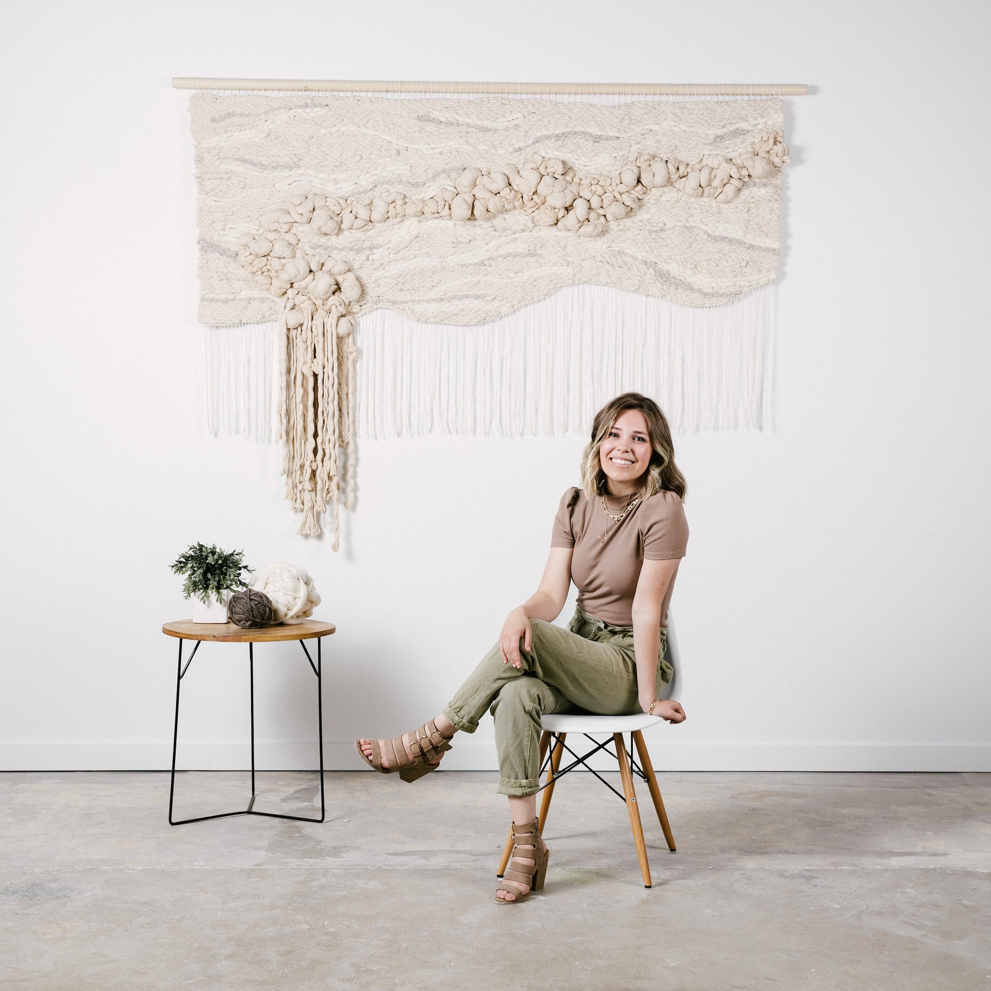 Eco-conscious woven tapestry utilizing plant-based fibers, highlighting the beauty of sustainable materials. Accent color in tones of beige.