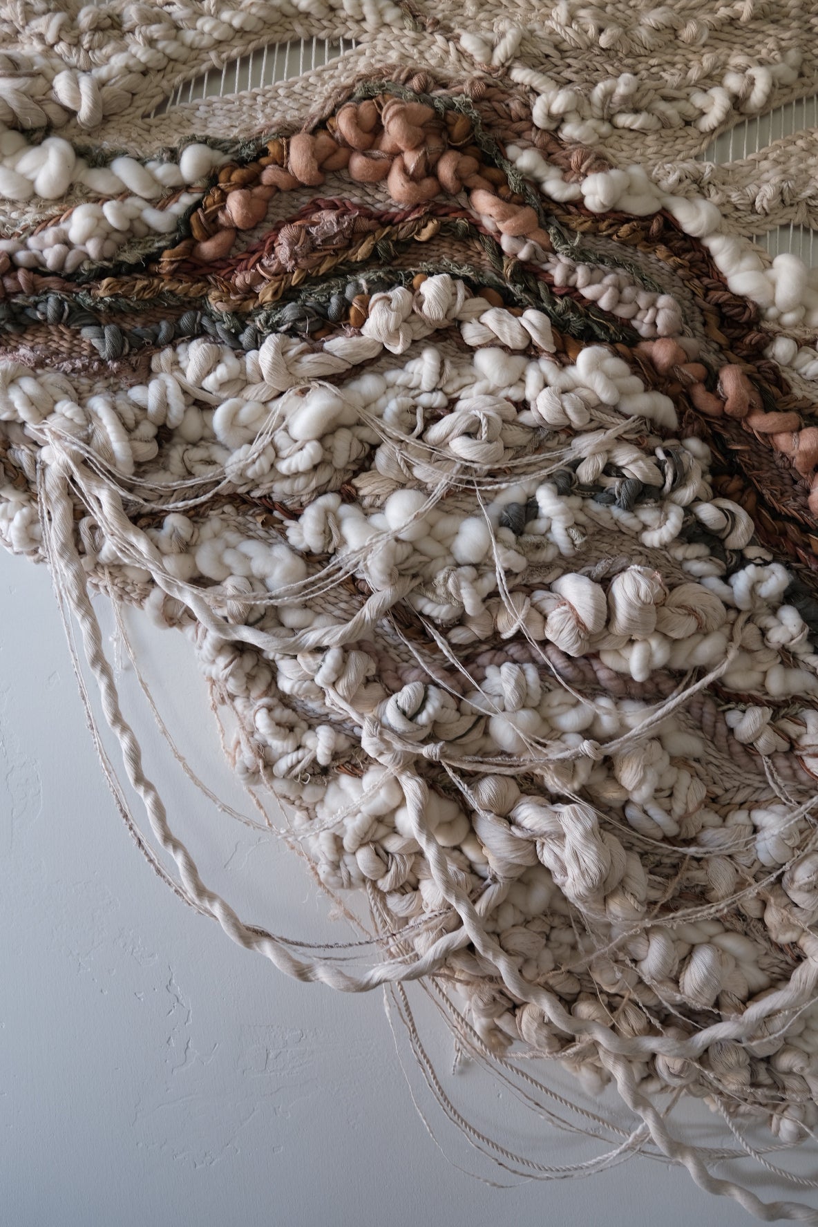 Abstract fiber art piece in calming beige and cream tones, created using cotton, wool, and recycled linen. knotted texture, and negative space.