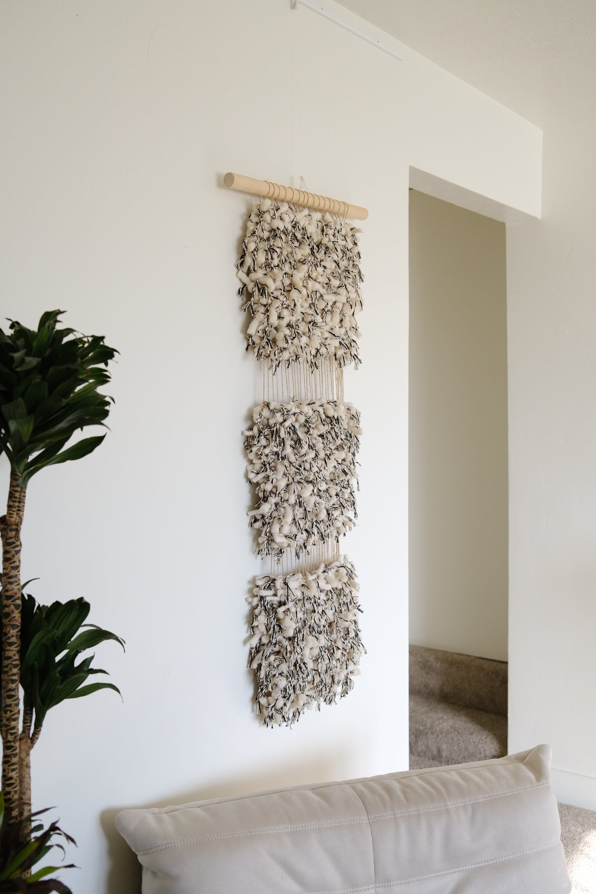 Abstract fiber art piece in calming beige and cream tones and black, created using cotton, wool, and recycled linen.
