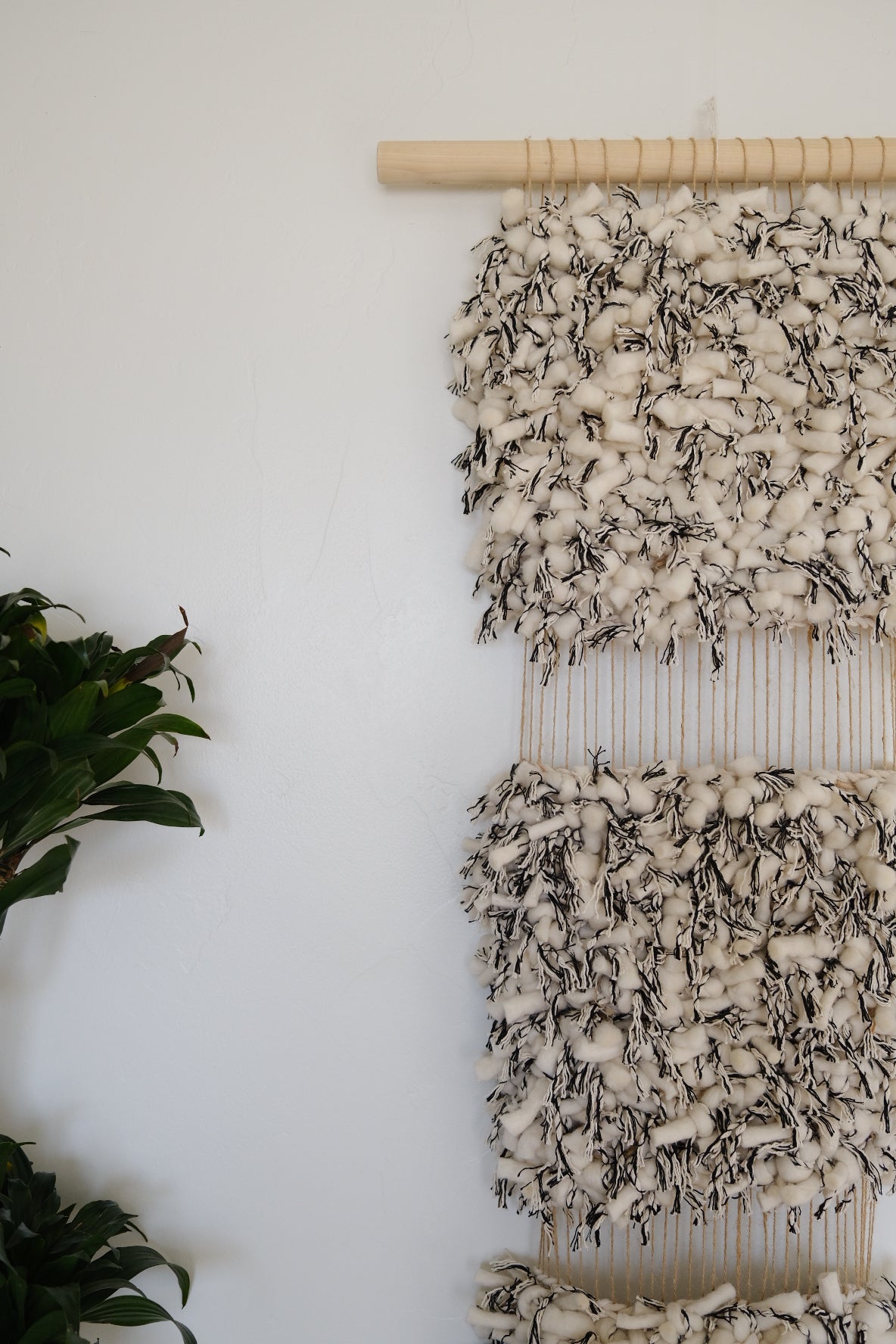 Abstract fiber art piece in calming beige and cream tones and black, created using cotton, wool, and recycled linen.