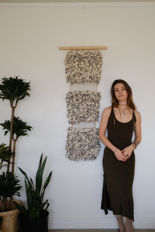 Abstract fiber art piece in calming beige and cream tones and black created using cotton, wool, and recycled linen.
Stacked art