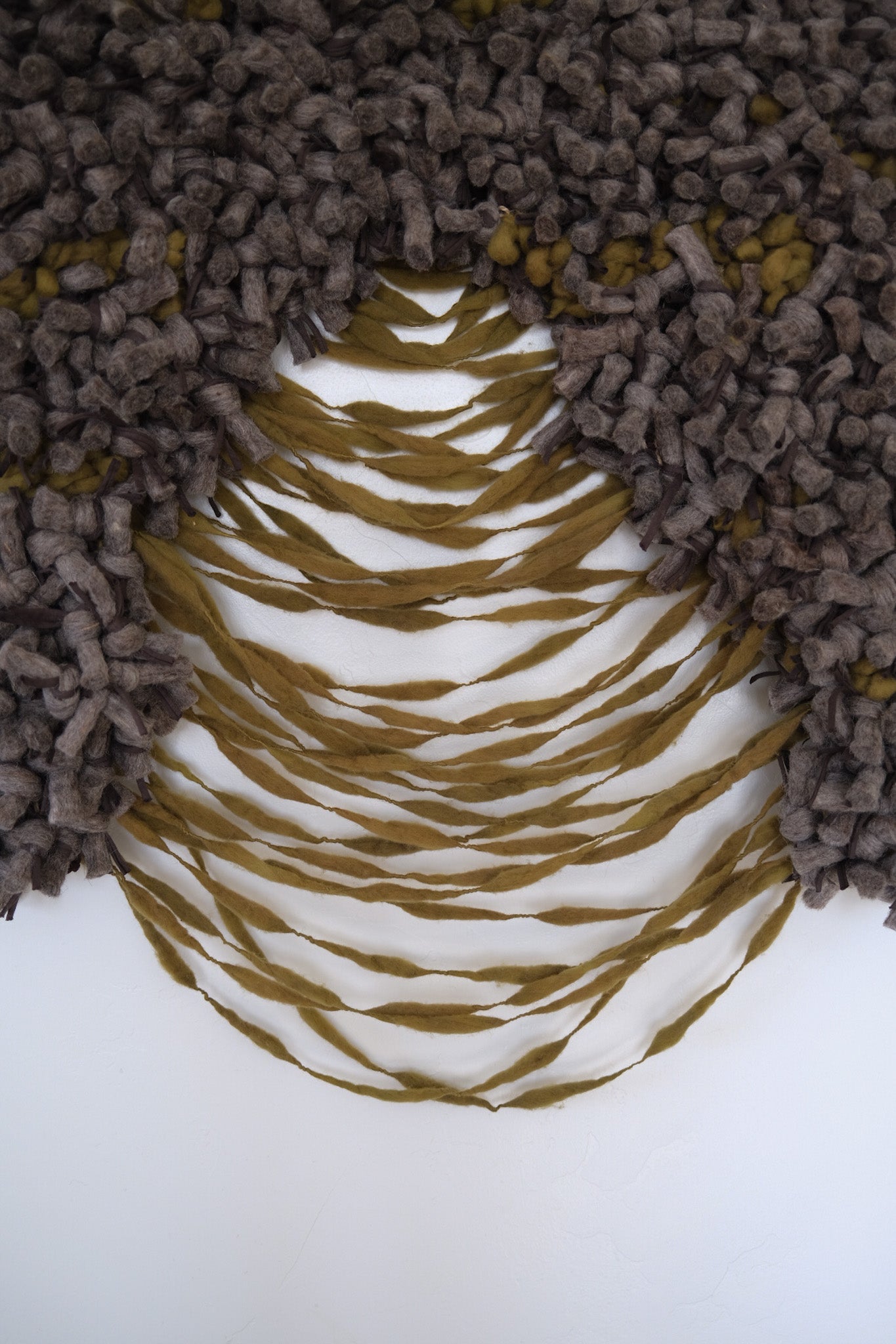 Neutral wall hanging featuring sculptural fiber techniques and a grounded, organic color palette.