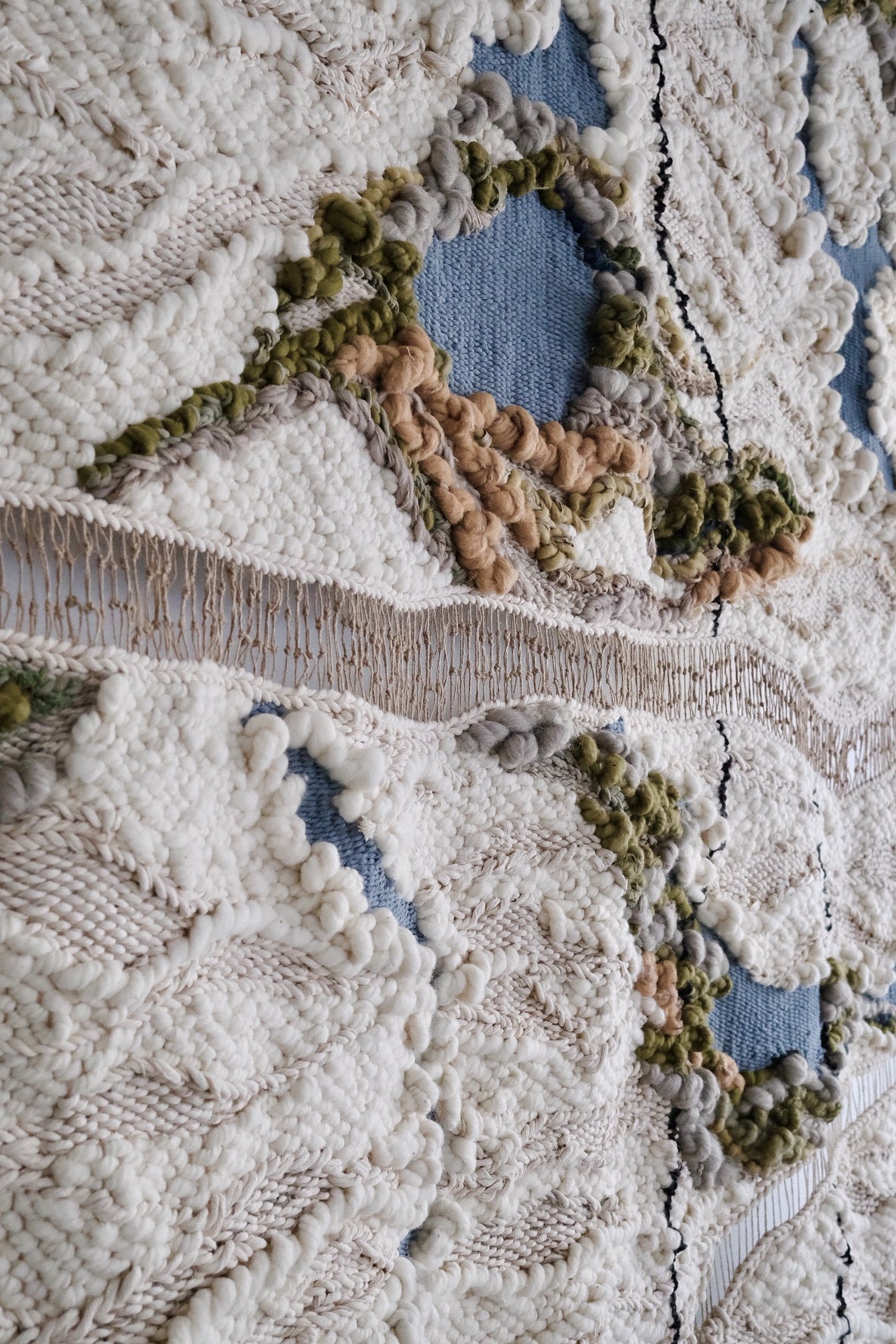 Contemporary woven wall hanging made from sustainable natural fibers. Richly textured tapestry with abstract, nature-inspired designs for high-end spaces.