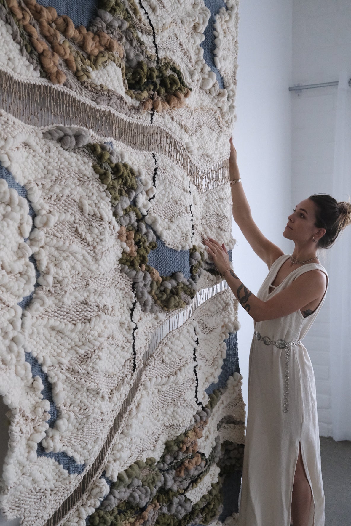 Artisanal fiber art tapestry handwoven with wool, cotton, and mixed natural materials. Unique large-scale wall decor for luxury interiors and design-forward homes.