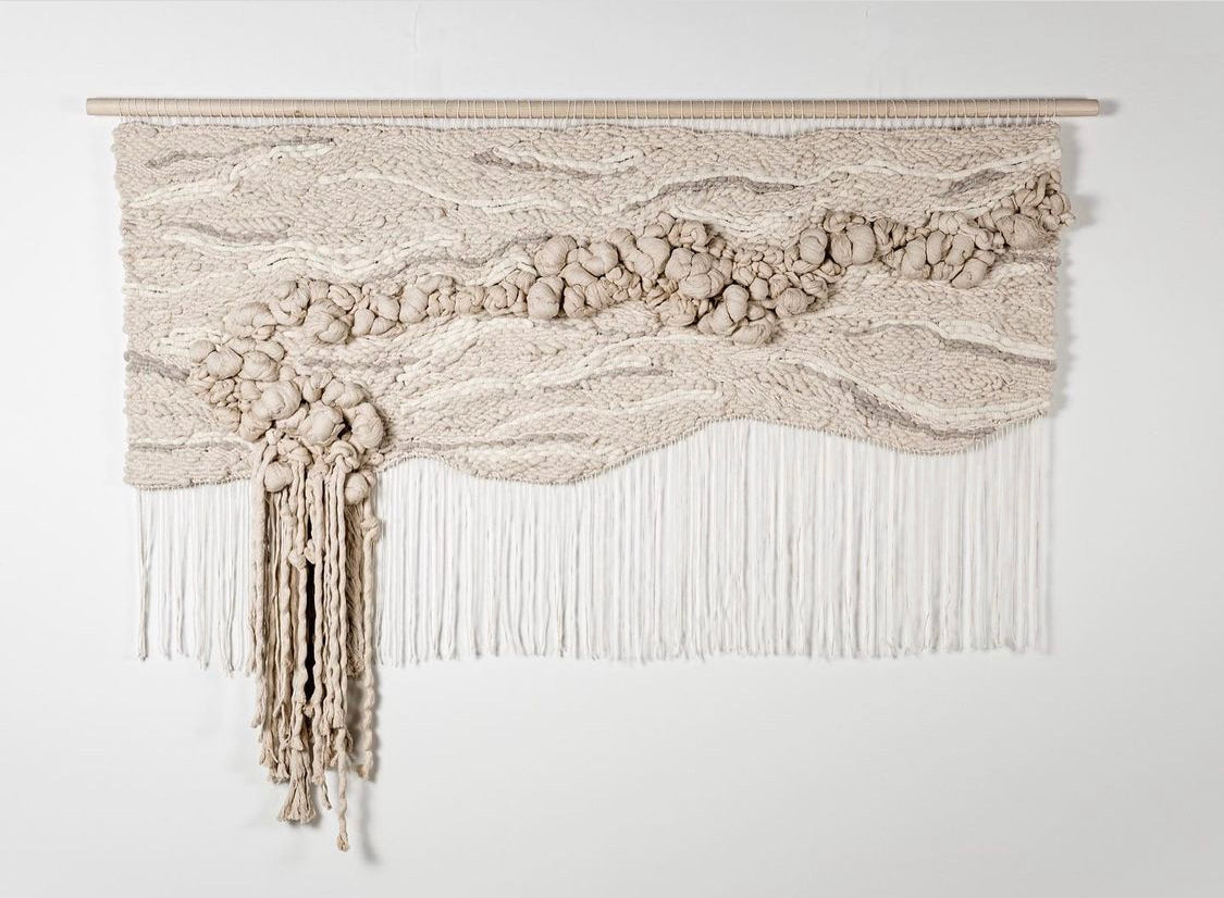 Eco-conscious woven tapestry utilizing plant-based fibers, highlighting the beauty of sustainable materials. Monochromatic pallet with knotted texture.