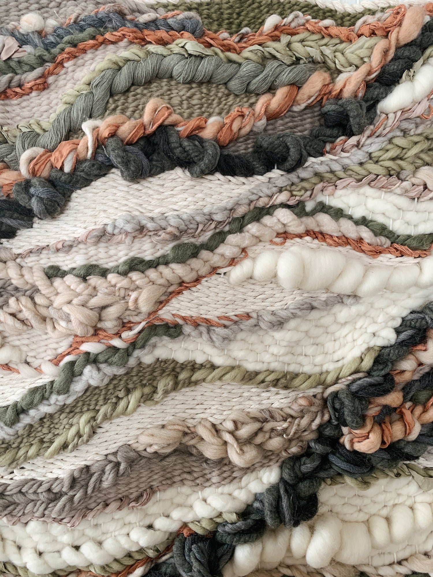 Soft fiber installation in muted tones, highlighting layered weaves and handcrafted movement. Textured and detailed fiber with natural flow.