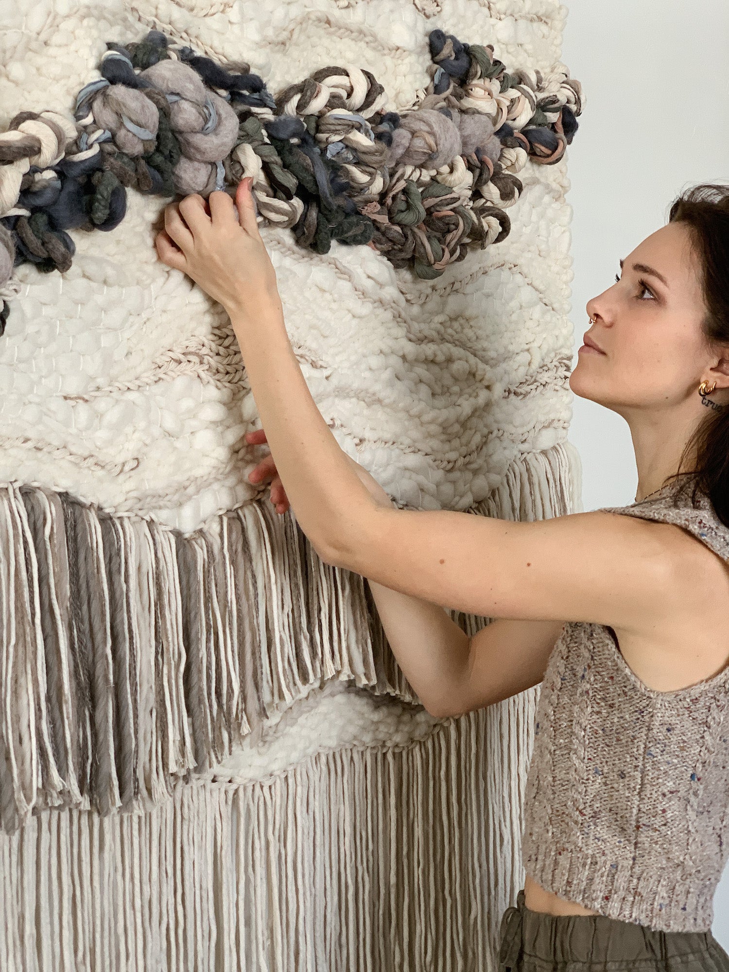 Wall-mounted fiber composition with cascading textures in soft, earthy palettes. Signature style, with soft fringe.