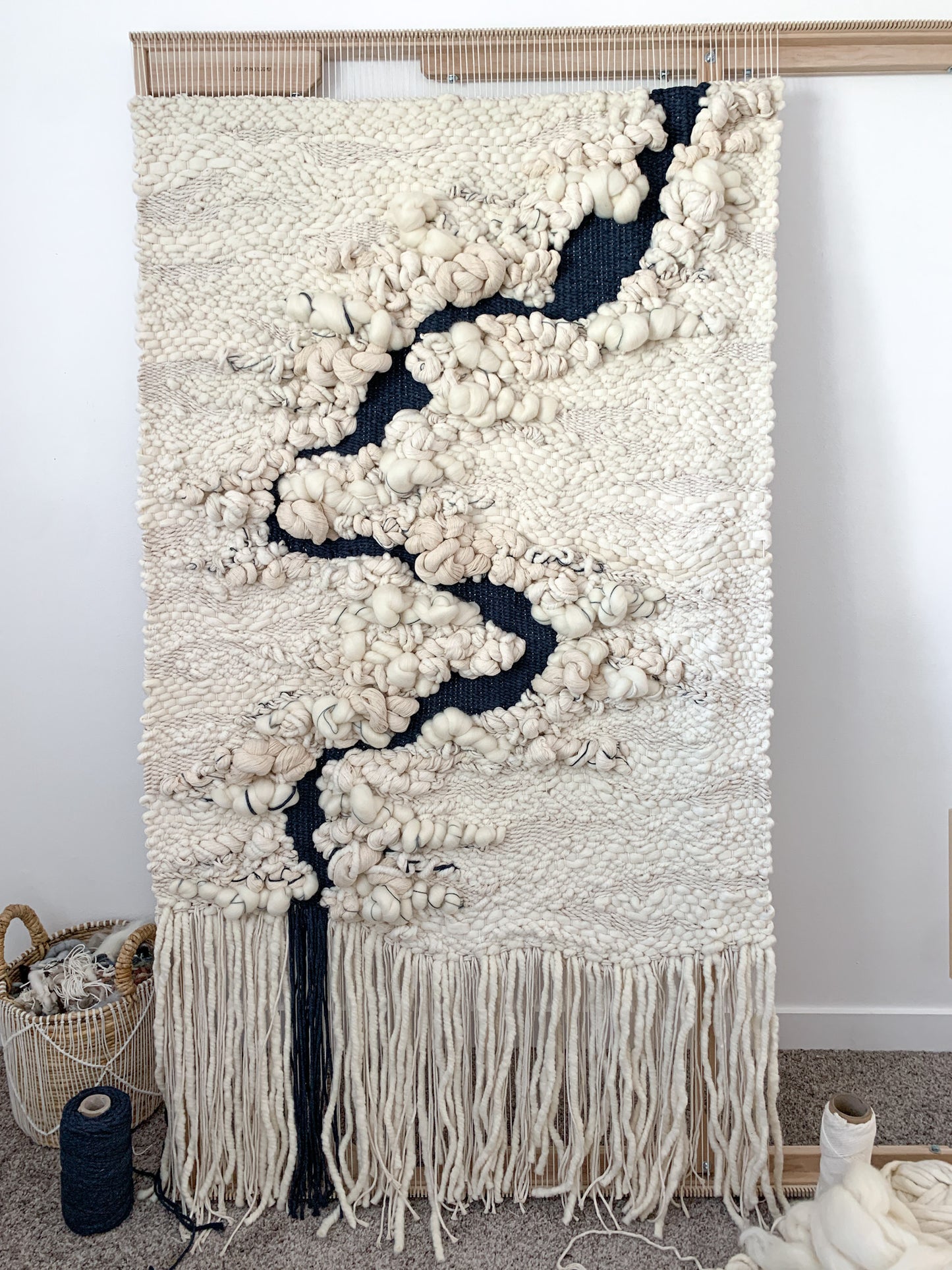 Eco-conscious woven tapestry utilizing plant-based fibers, highlighting the beauty of sustainable materials. Water fall art.