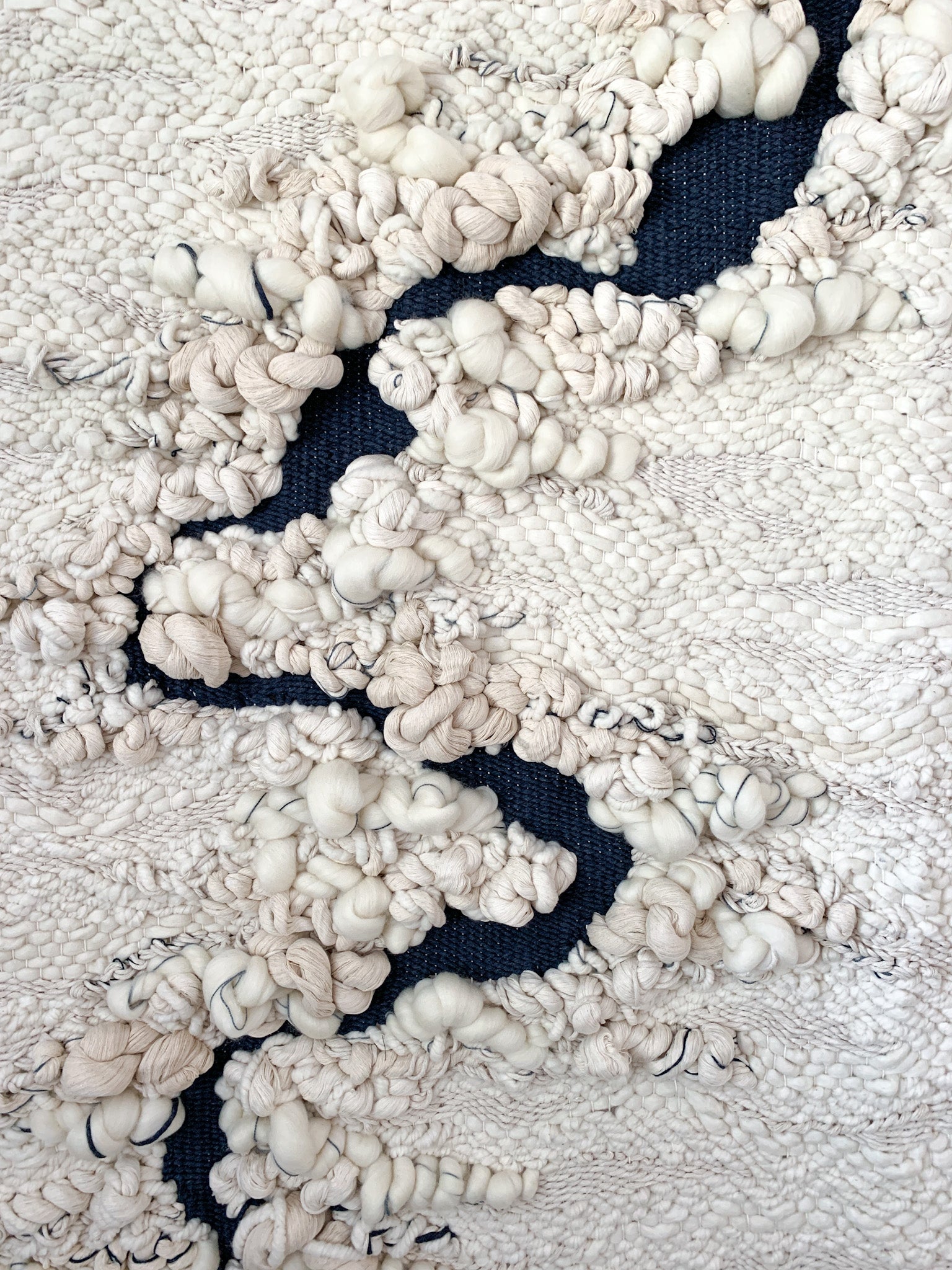 Eco-conscious woven tapestry utilizing plant-based fibers, highlighting the beauty of sustainable materials. Accent color in blue with ivory and beige.