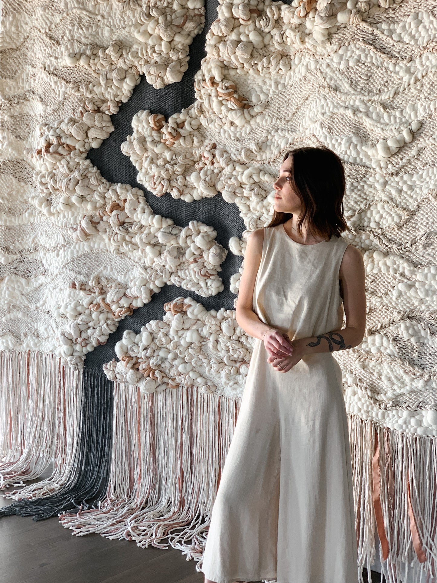 Wool and cotton art piece woven into an abstract landscape-inspired design with rich tactile contrast.
Accent color in slate blue, salmon, beige and ivory. Heavy knotting and woven texture.