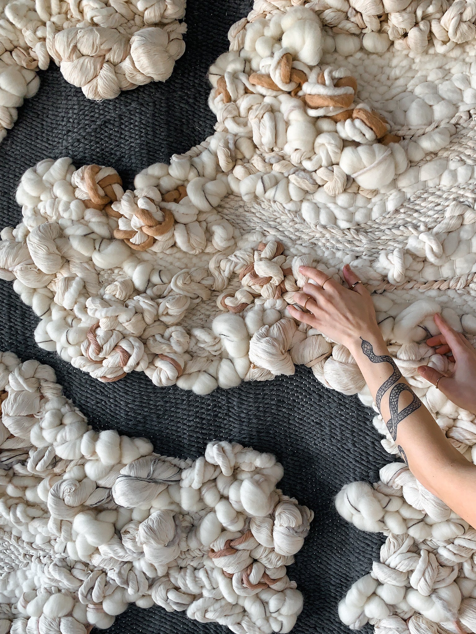 Wool and cotton art piece woven into an abstract landscape-inspired design with rich tactile contrast.
Knotted features with organic shape.