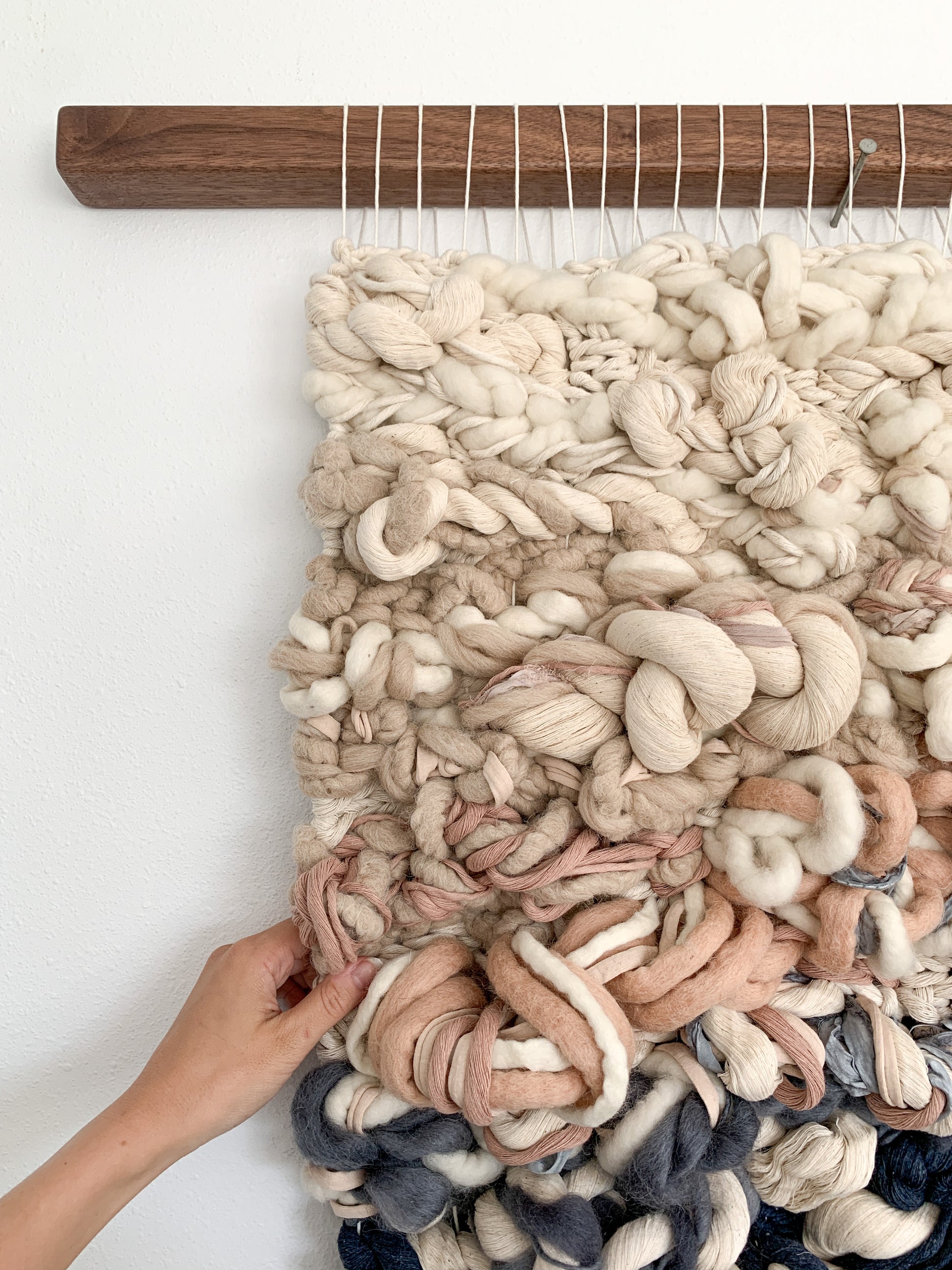 Handcrafted woven tapestry with intricate knotting techniques, creating a dynamic visual centerpiece.