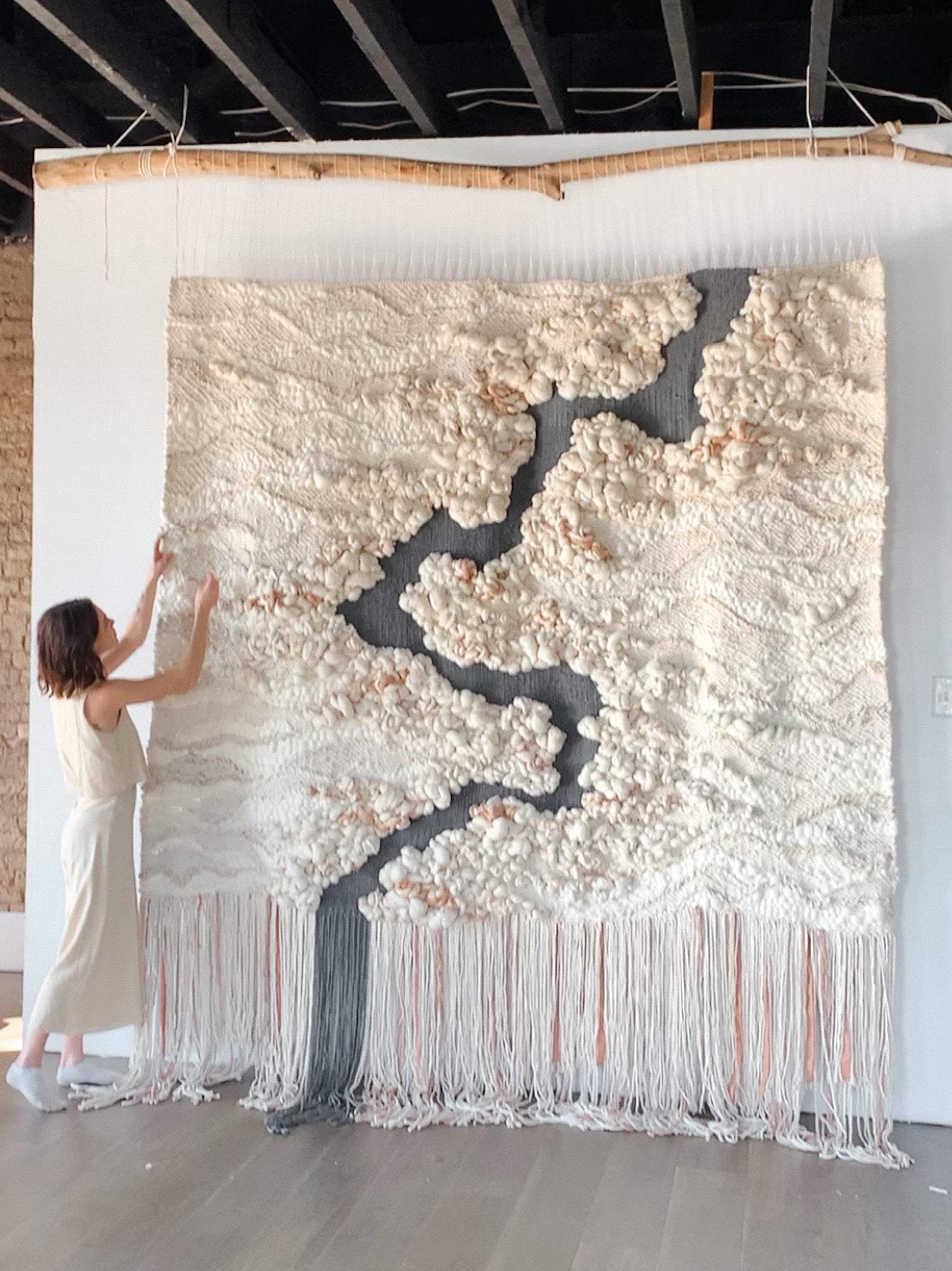 Wool and cotton art piece woven into an abstract landscape-inspired design with rich tactile contrast.