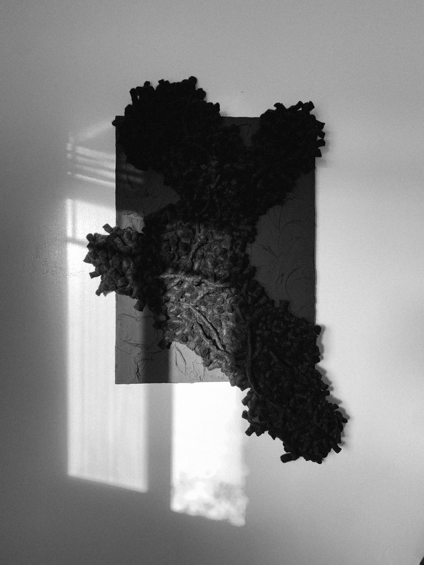 Contemporary textile wall art with bold textures, enhancing modern interiors. Accent color in black.