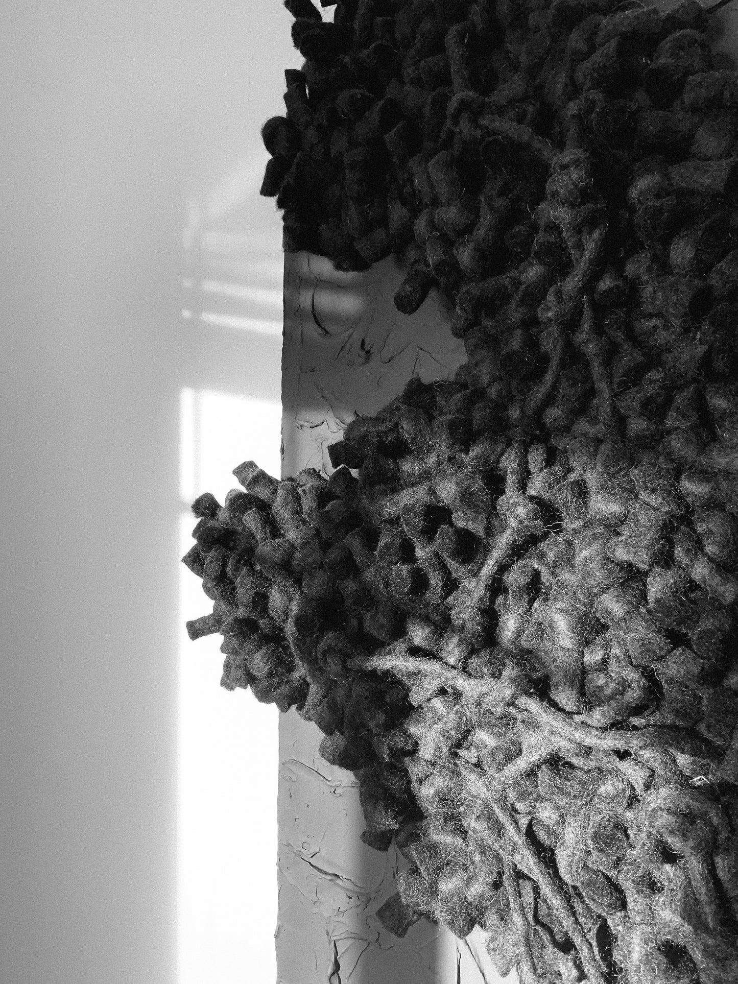 Contemporary textile wall art with bold textures, enhancing modern interiors. Accent color in black.