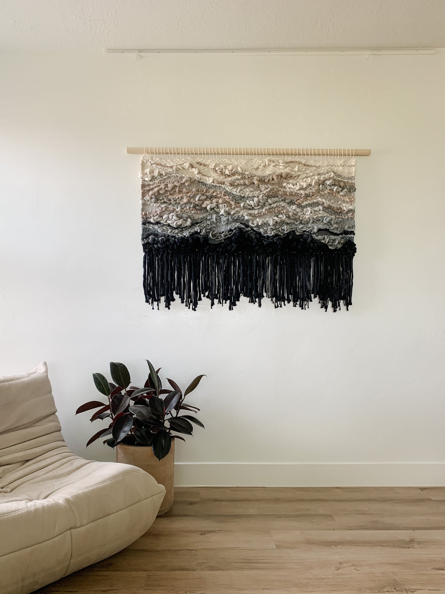 Contemporary woven wall art with layered textures and earthy hues, adding depth to any interior space.