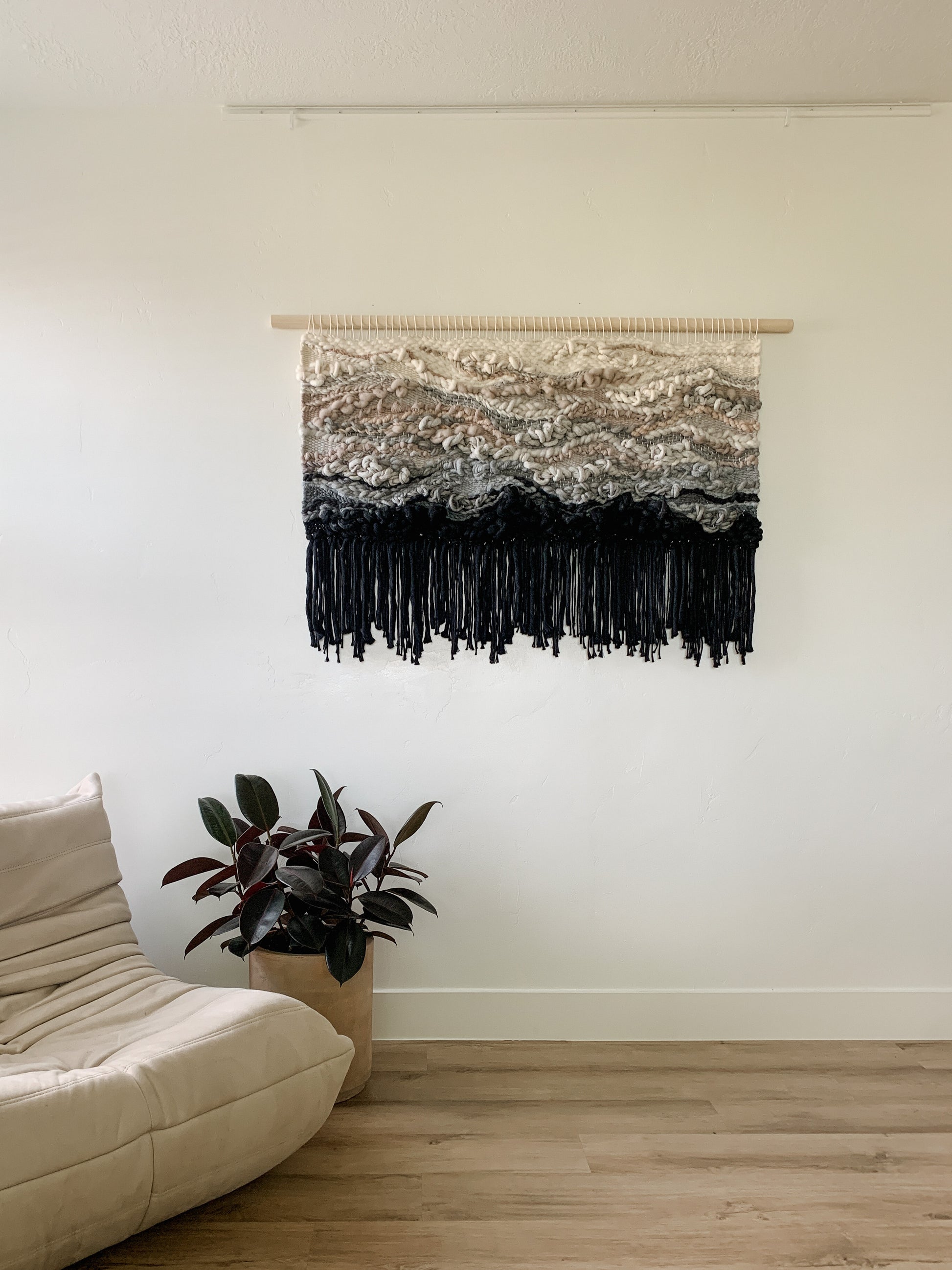 Contemporary woven wall art with layered textures and earthy hues, adding depth to any interior space.