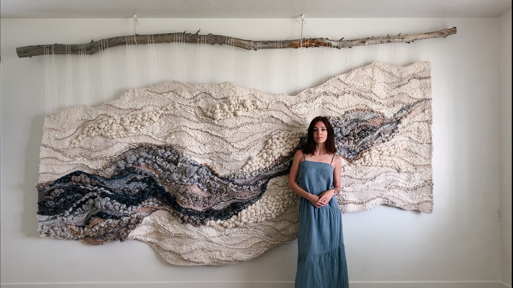 Modern woven wall hanging featuring soft, sculptural forms and a subtle palette of warm neutrals, blues and ivory. Large scale art.