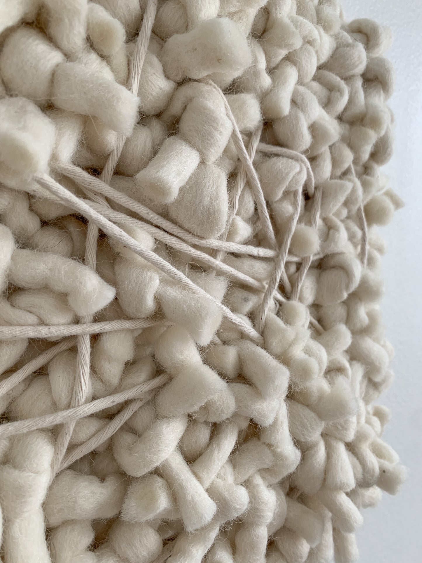 Contemporary fiber expression made with eco-conscious materials and intuitive patterning.
Knotted face with calming tones.