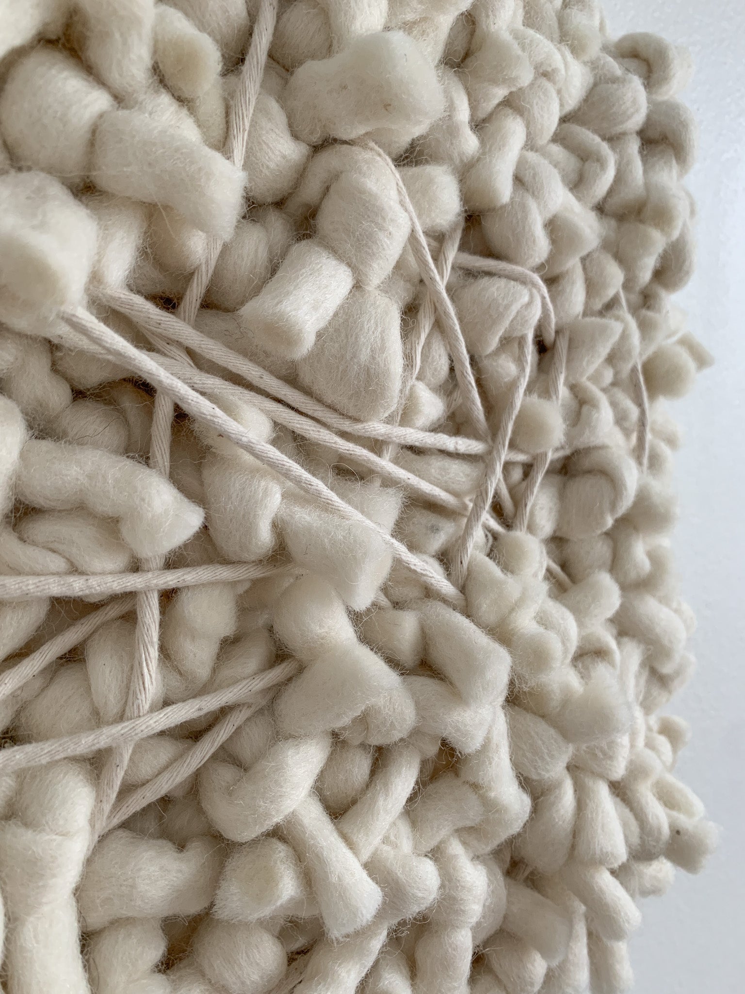 Contemporary fiber expression made with eco-conscious materials and intuitive patterning.
Knotted face with calming tones.