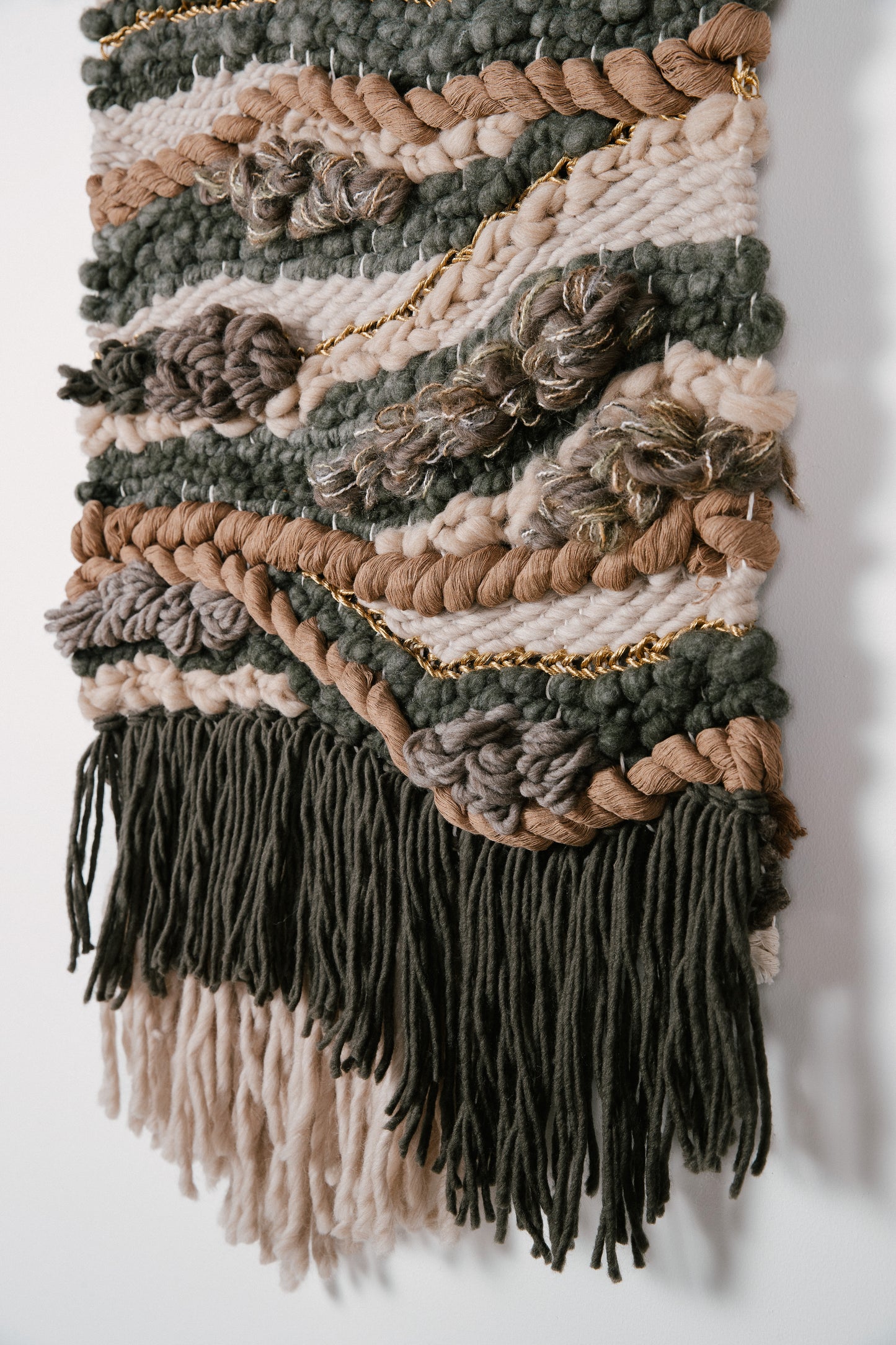 Organic fiber wall art piece utilizing natural wool and cotton, exuding warmth and tactile appeal. Knotted texture and finer threads.