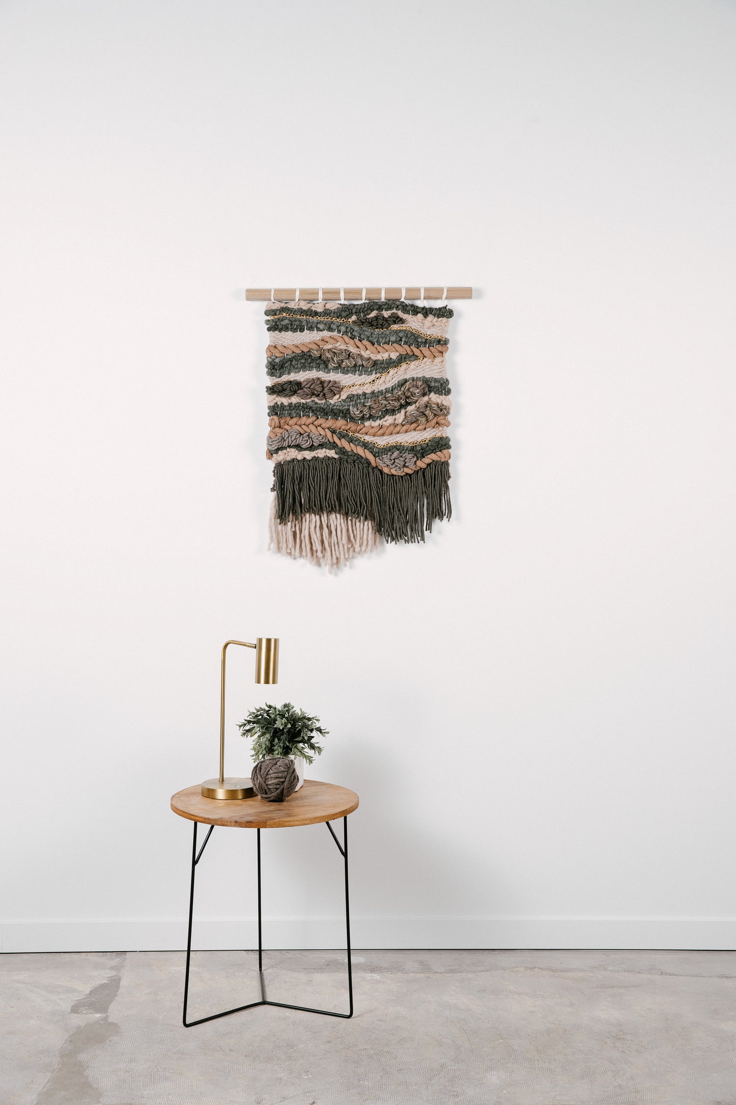 Organic fiber wall art piece utilizing natural wool and cotton, exuding warmth and tactile appeal.