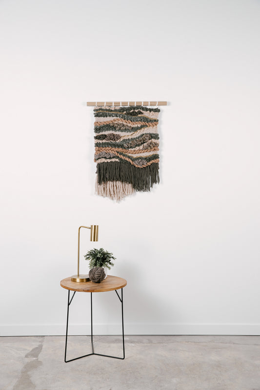 Organic fiber wall art piece utilizing natural wool and cotton, exuding warmth and tactile appeal.