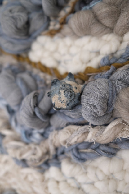 Textural detail of a woven textile artwork by Rebecca Whitaker, featuring wool, cotton, and organic fibers.