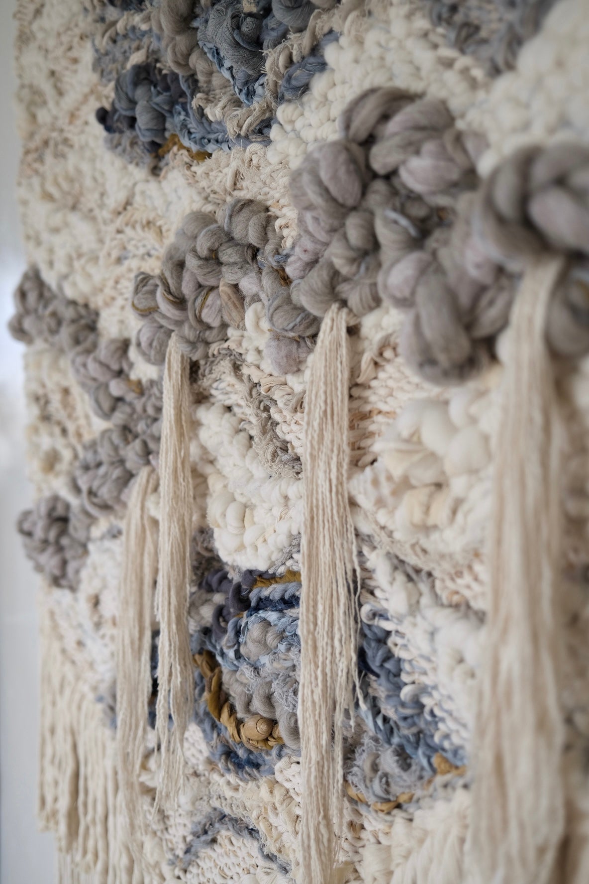 Symbolic material detail in a handwoven tapestry by Rebecca Whitaker, created through an intuitive design process.