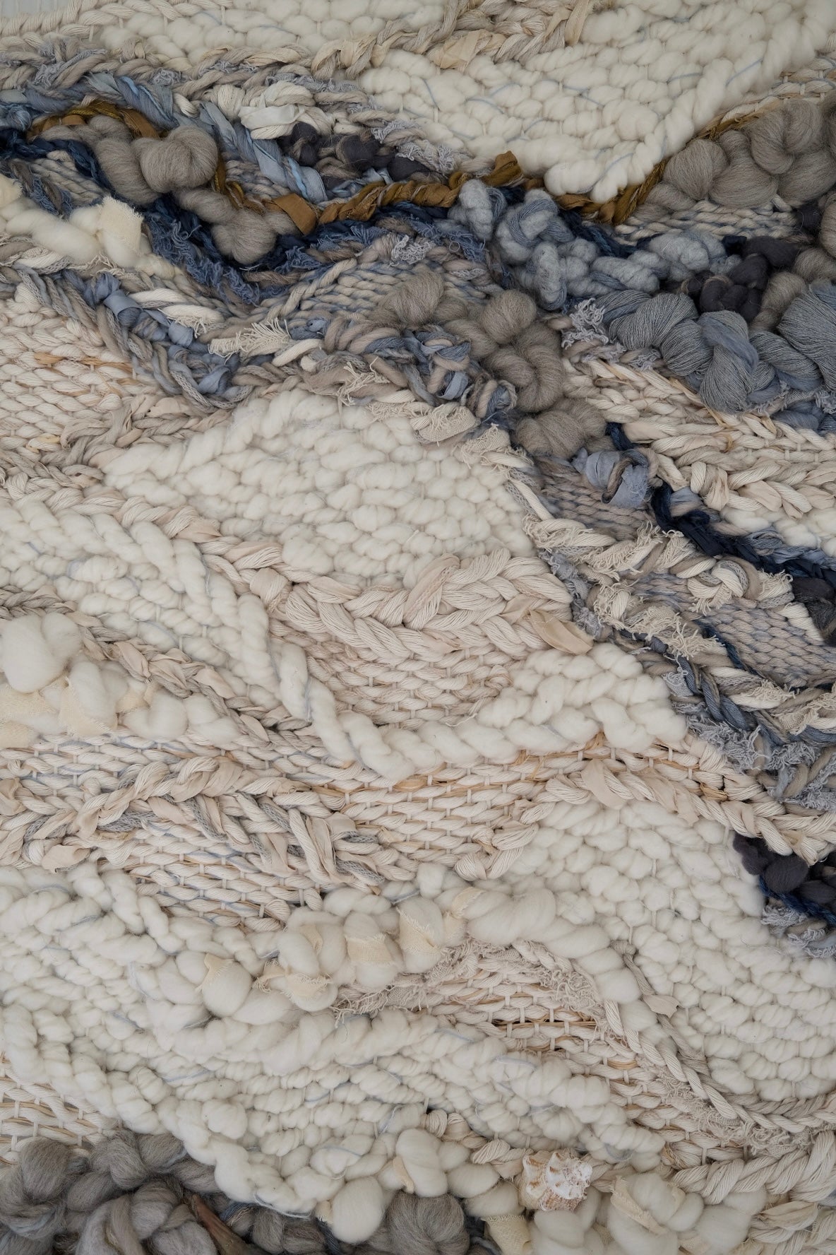 Close-up detail of handwoven tapestry by Rebecca Whitaker, showing natural fiber texture and knotting.