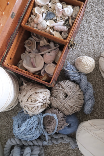 seashells and natural fibers used in the intentional custom woven wall hangings by rebecca whitaker