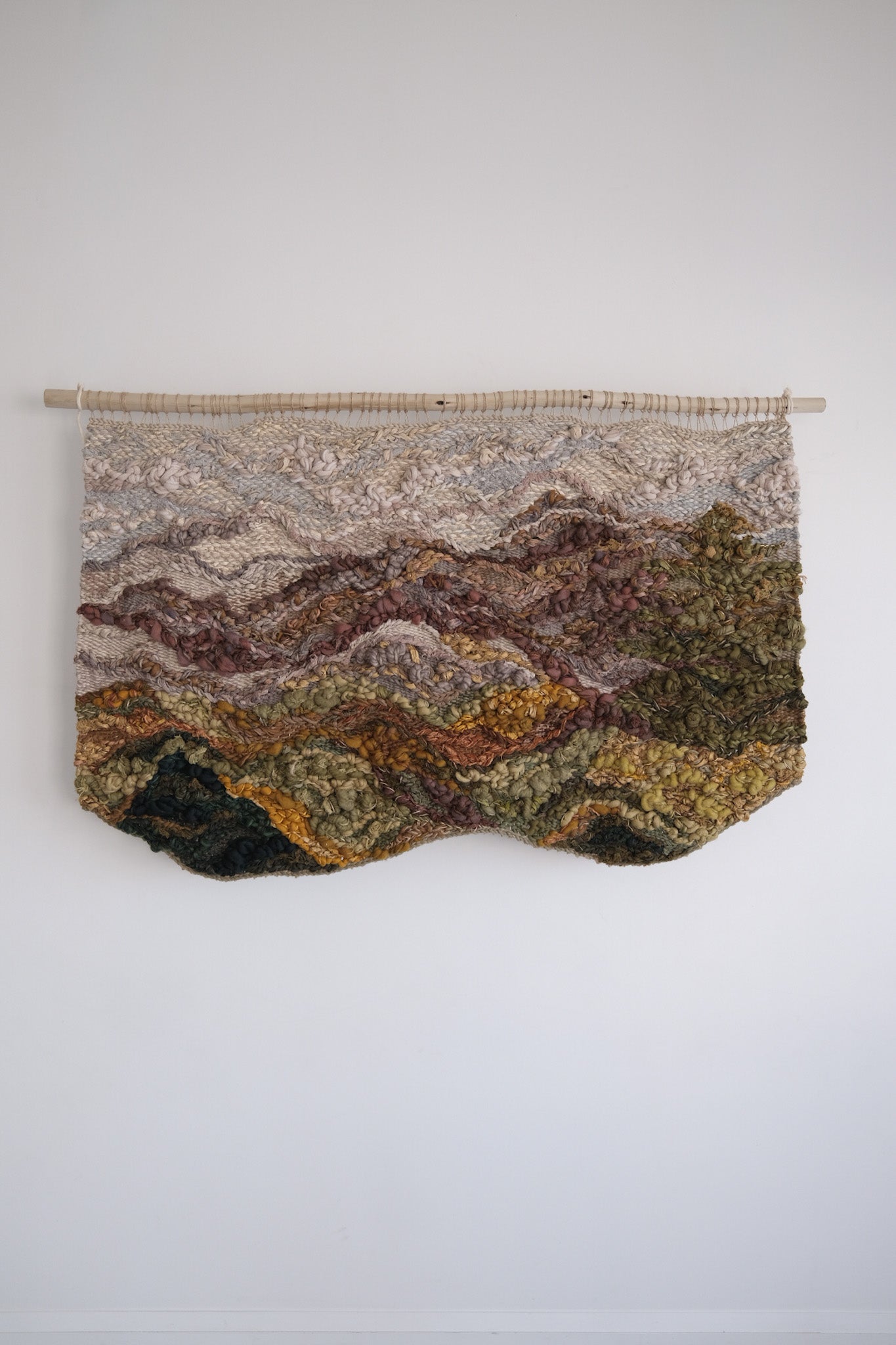 Custom woven wall hanging by Rebecca Whitaker, created as a symbolic textile commission for a home interior.