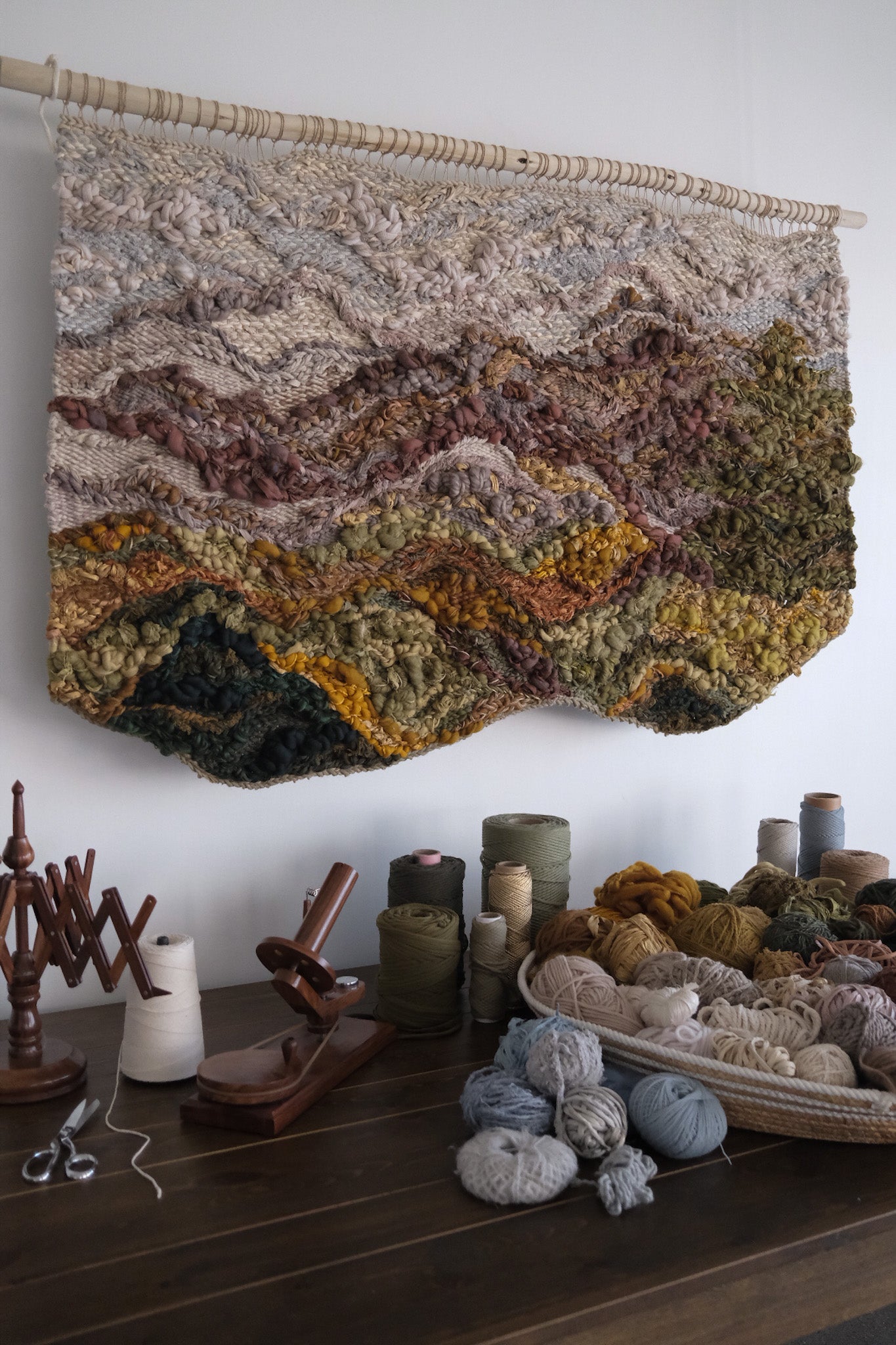 Symbolic material detail in a handwoven tapestry by Rebecca Whitaker, created through an intuitive design process.