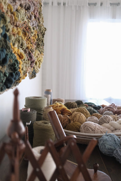 Symbolic material detail in a handwoven tapestry by Rebecca Whitaker, created through an intuitive design process.