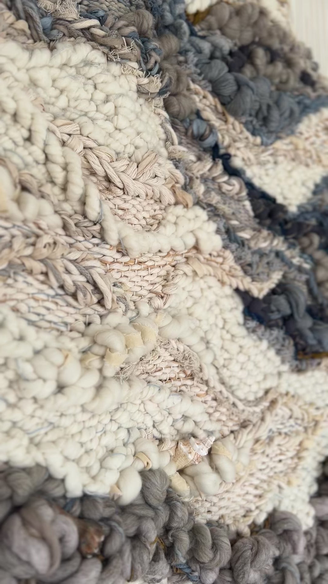 Close-up detail of handwoven tapestry by Rebecca Whitaker, showing natural fiber texture and knotting.